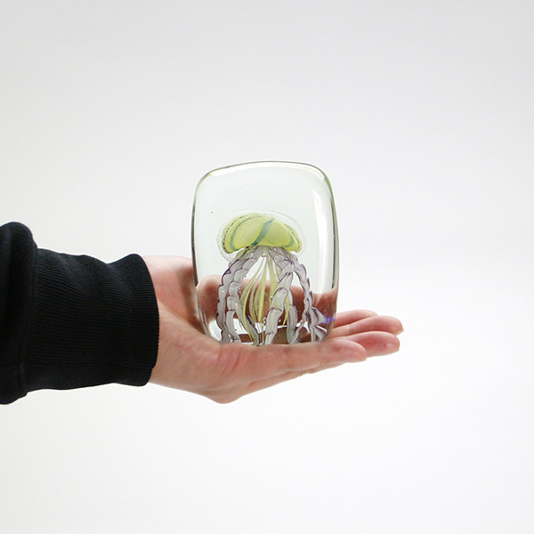 四角い水の中に１匹のクラゲが浮遊しているかのようなガラス製オブジェ。