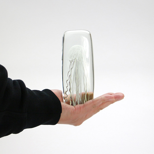 四角い水の中に１匹のクラゲが浮遊しているかのようなガラス製オブジェ。